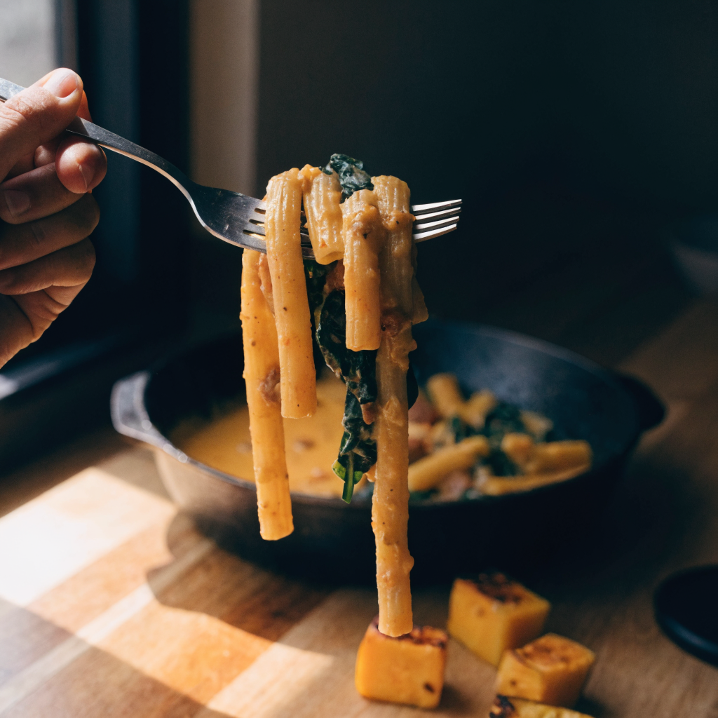 Close-up of butternut squash pasta with sausage and spinach